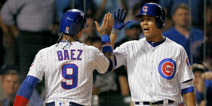 Javier Baez (left) and Jose Quintana (right) were just a few of the Cubs to experience success at the plate in the blowout win for Chicago. (Photo Credit: Jim Young-USA TODAY Sports)