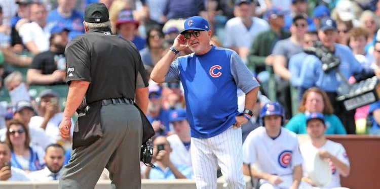 Chicago Cubs manager Joe Maddon (70) argues with umpire Joe West (22) during the first inning against the Pittsburgh Pirates at Wrigley Field. - Dennis Wierzbicki-USA TODAY Sports