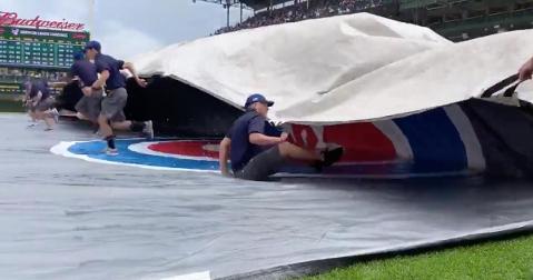 Giving new meaning to "slip-and-slide," this unlucky grounds-crew employee was engulfed by the Wrigley Field tarp.