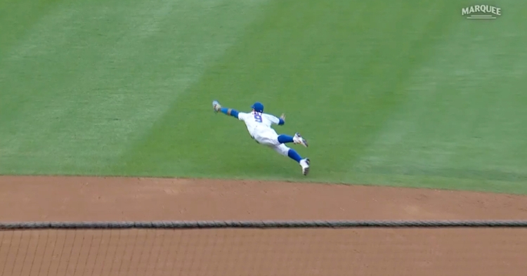 Chicago Cubs shortstop JAVIER BAEZ points to the crowd after hitting a home  run