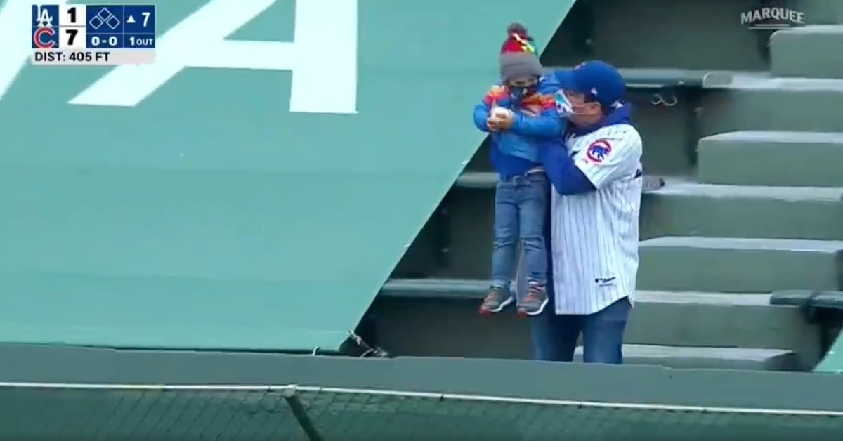 Cubs fan dad teaches young son about throwing back HR balls at Wrigley