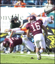 <font class=caption>Travis Zachery was injured catching this 23-yard TD pass from Woody Dantzler. The touchdown was his 18th of the season, a school record.</font>