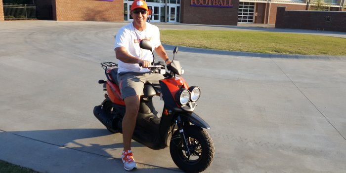 Swinney rode his moped to practice Monday