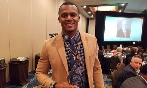 Watson poses with the Collegiate Player of the Year Award he won earlier this year