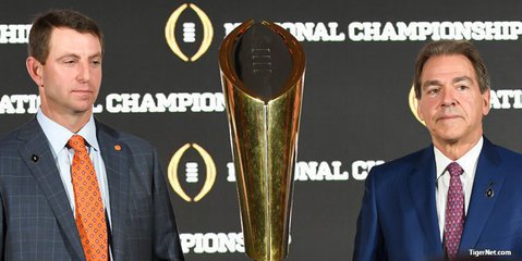 Swinney and Saban pose with the trophy Sunday morning