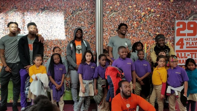 Members of the team pose with some of the kids