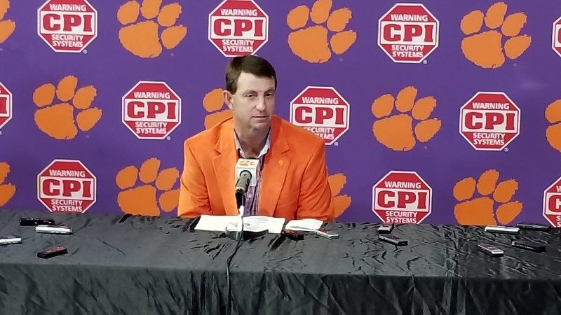 Swinney shows off his orange jacket Wednesday