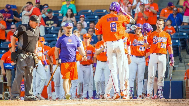 Davidson is greeted at home plate after his grand slam (Photo by Christopher Sloan)