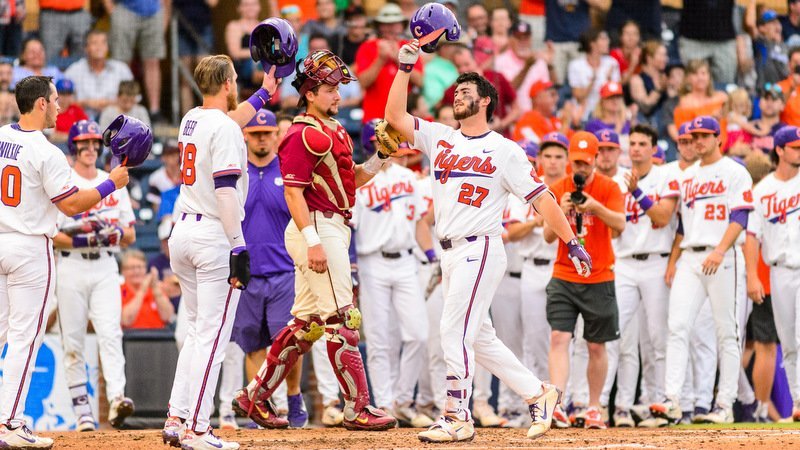 Chris Williams is greeted at home plate after his three-run homer Saturday (Photo by David Grooms)