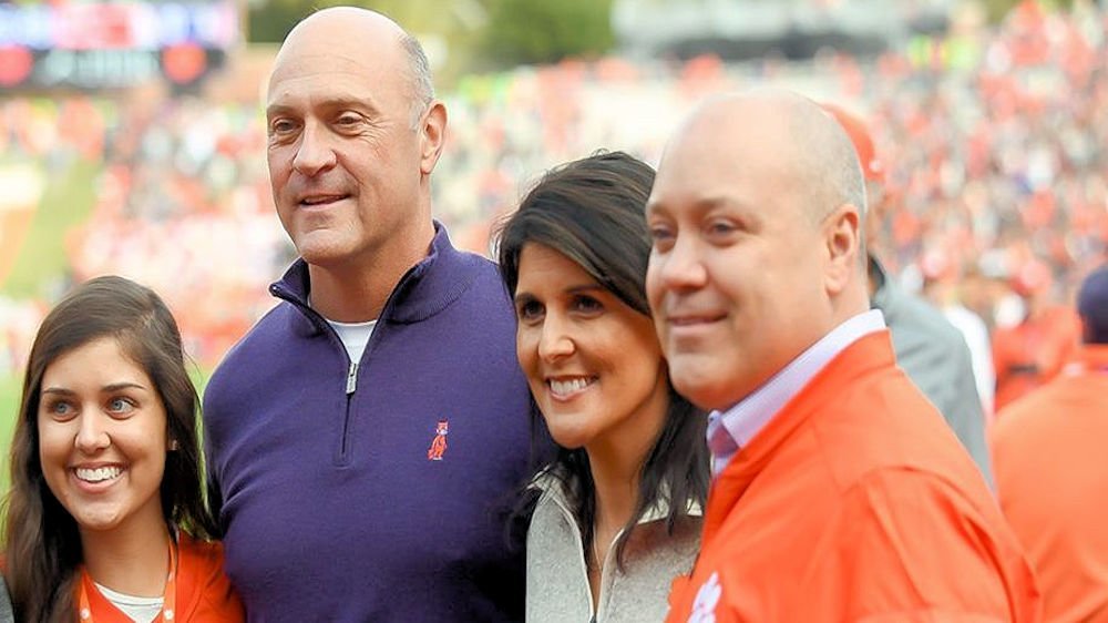 Nikki Haley with her family and President Clements during a football game