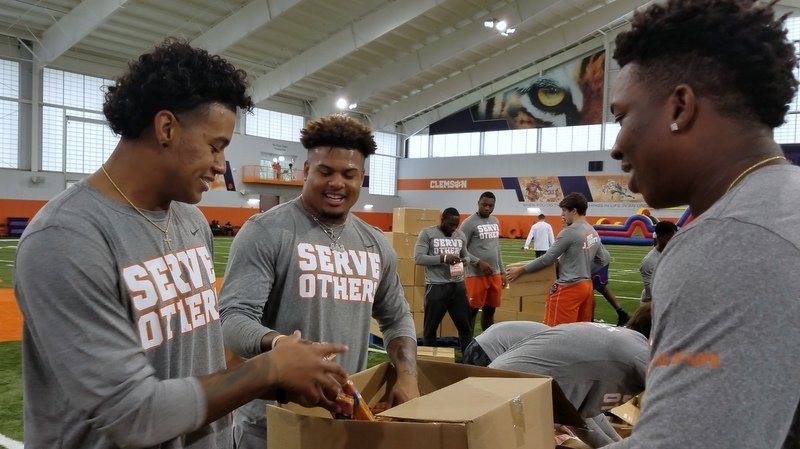 Braden Galloway, Xavier Thomas, and KJ Henry prepare boxes