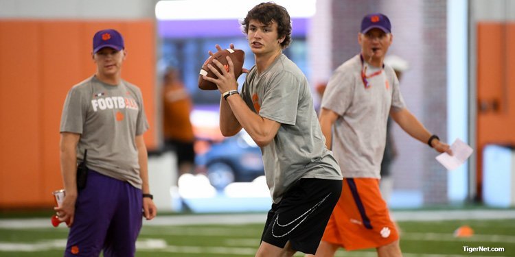 Davis Beville throws under the watchful eye of Brandon Streeter