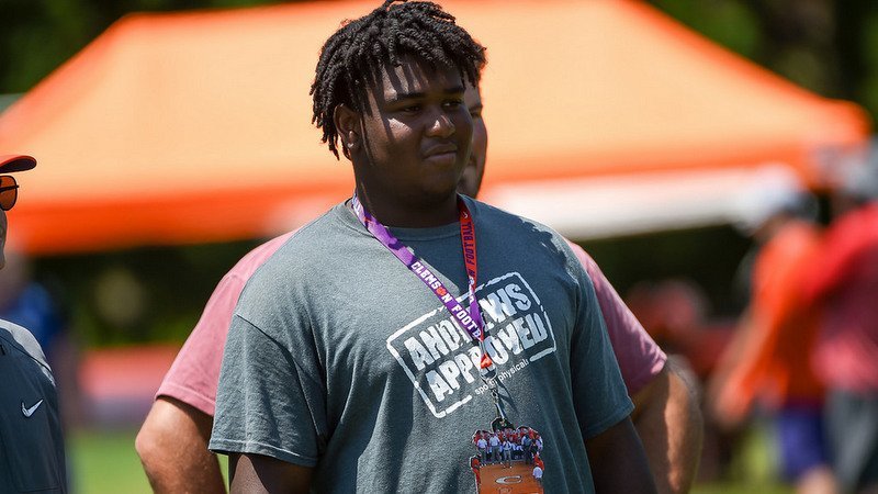 Medley watches a workout last week at Swinney's high school camp