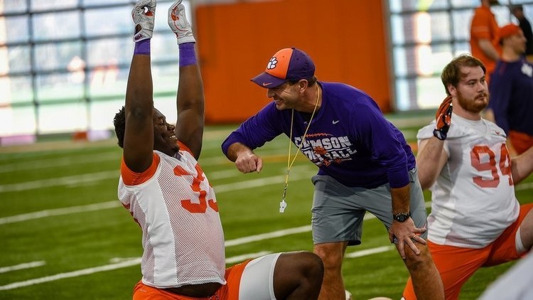 Swinney jokes with Ruke Orhorhoro at a recent practice