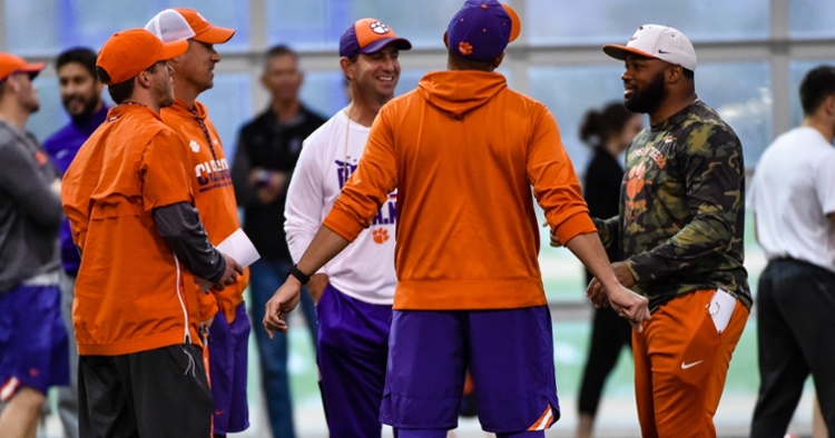 Head coach Dabo Swinney meets with his staff before Friday's practice