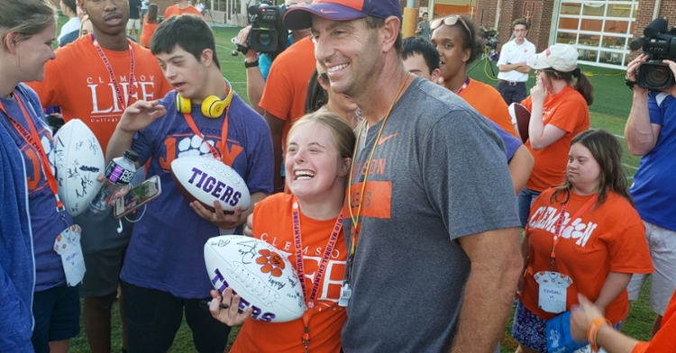 Dabo Swinney poses with a student after practice Wednesday.