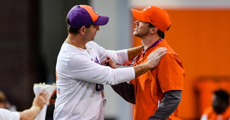 Grisham (right) gets some advice from head coach Dabo Swinney.