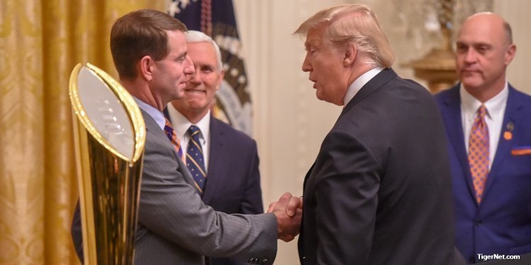 Swinney (left) shakes the hand of President Donald Trump
