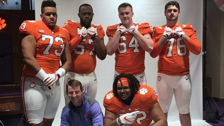 Clemson head coach Dabo Swinney poses with the offensive line prospects