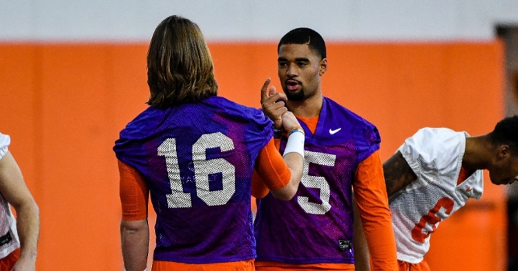 Trevor Lawrence and DJ Uiagalelei share a special handshake before practice