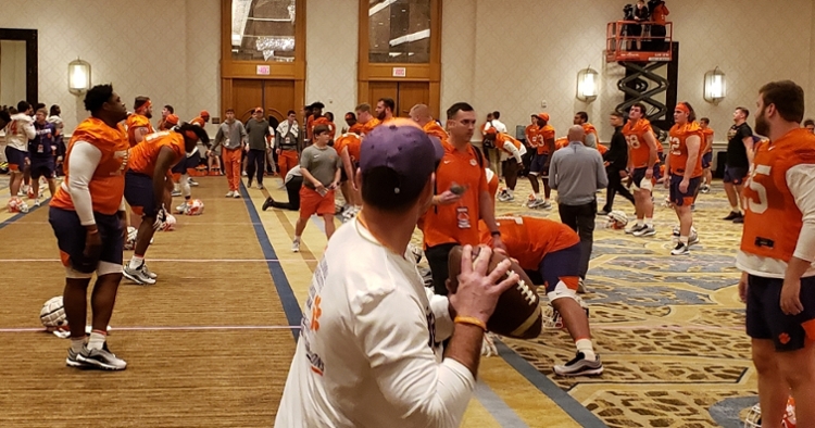 Clemson head coach Dabo Swinney throws a pass in the ballroom Saturday