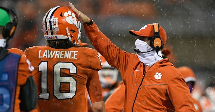 Swinney pats Lawrence on the helmet after a touchdown Saturday. (Photo courtesy ACC)